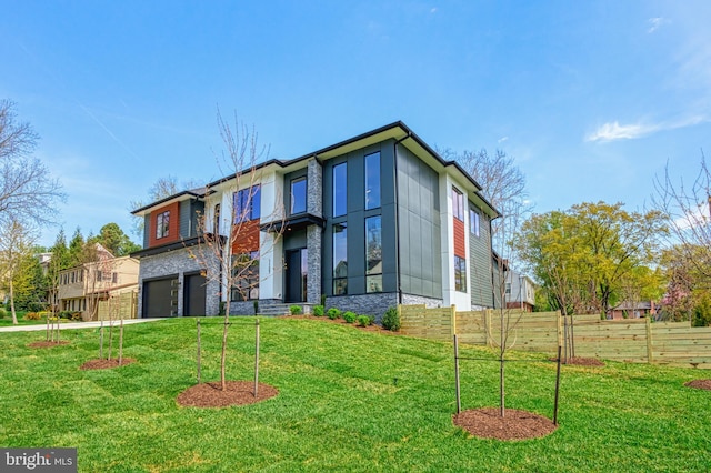 1127 Guilford Ct, Mclean, VA 22101 - view of front of house featuring a front yard, fence, stone siding, and a garage