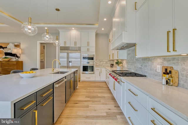 1127 Guilford Ct, Mclean, VA 22101 - kitchen featuring light wood-type flooring, white cabinetry, light countertops, a sink, and stainless steel appliances