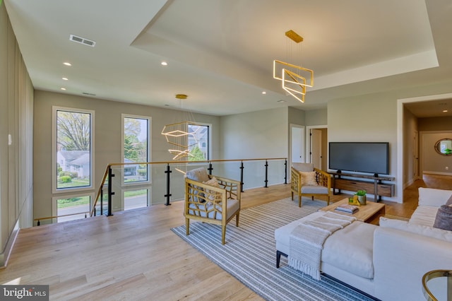 1127 Guilford Ct, Mclean, VA 22101 - living room with a chandelier, light wood-style floors, and a healthy amount of sunlight