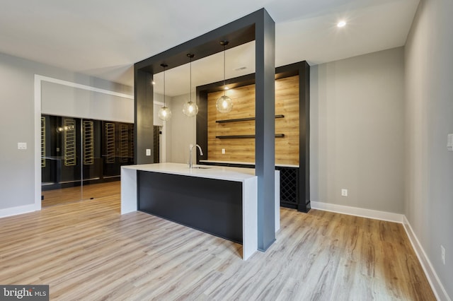 1127 Guilford Ct, Mclean, VA 22101 - interior space featuring light wood-style flooring, a sink, light countertops, hanging light fixtures, and baseboards