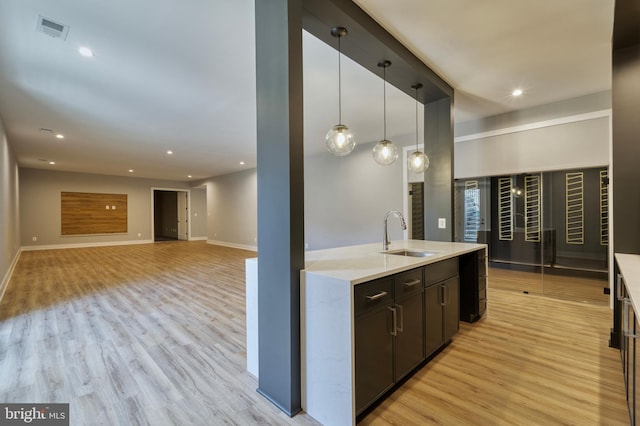 1127 Guilford Ct, Mclean, VA 22101 - kitchen with light wood-style flooring, baseboards, a sink, and visible vents