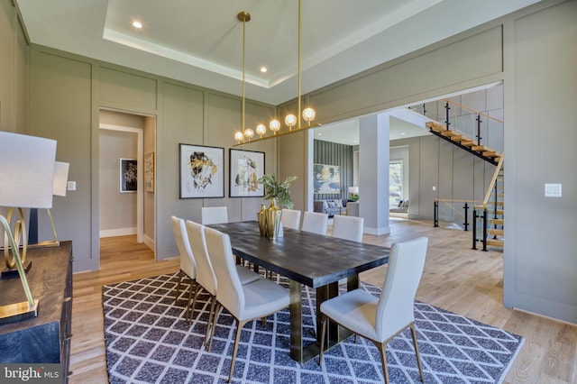1127 Guilford Ct, Mclean, VA 22101 - dining space featuring stairs, light wood-type flooring, baseboards, and a raised ceiling