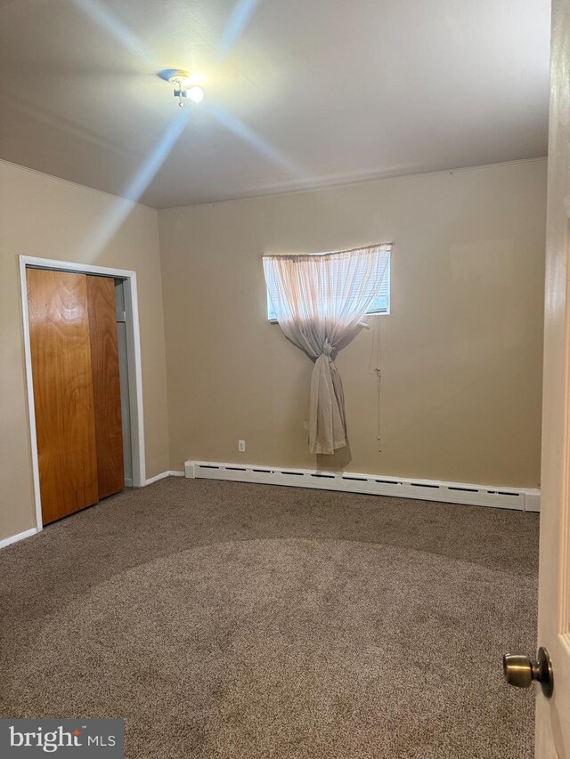 4561 N Camac St, Philadelphia, PA 19140 - unfurnished bedroom with baseboard heating, baseboards, and carpet floors