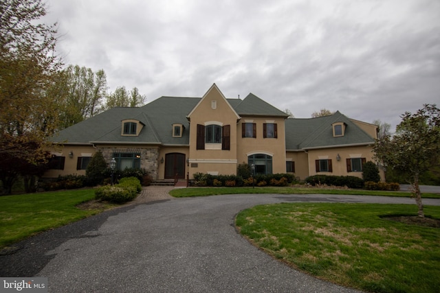 2916 Westbrook Ln, Bowie, MD 20721 - french country style house featuring curved driveway, stucco siding, and a front yard
