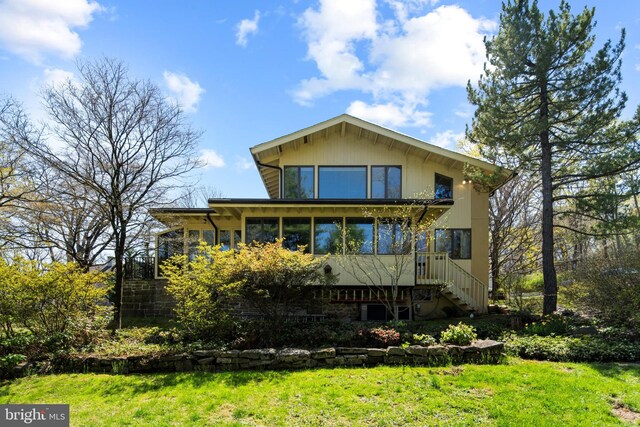 2984 N Sugan Rd, New Hope, PA 18938 - back of property with a sunroom, a yard, and stairs