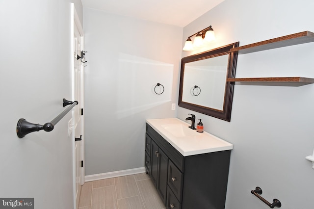 bathroom featuring vanity and baseboards