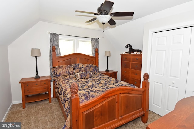 bedroom with ceiling fan, vaulted ceiling, baseboards, a closet, and carpet flooring