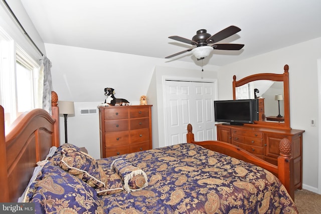 carpeted bedroom featuring a ceiling fan, visible vents, and a closet