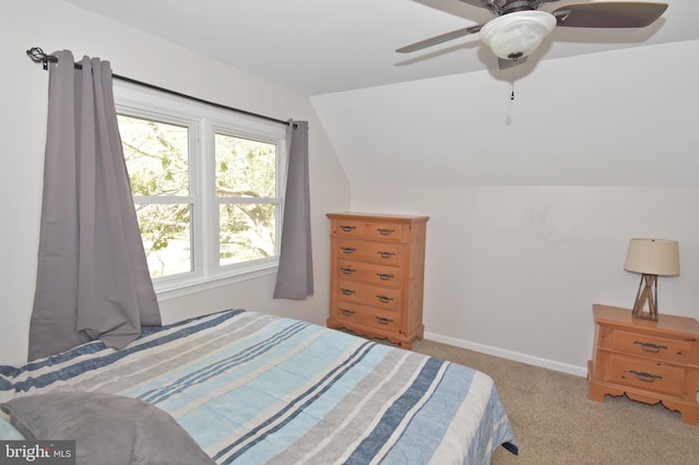 carpeted bedroom featuring baseboards, a ceiling fan, and vaulted ceiling