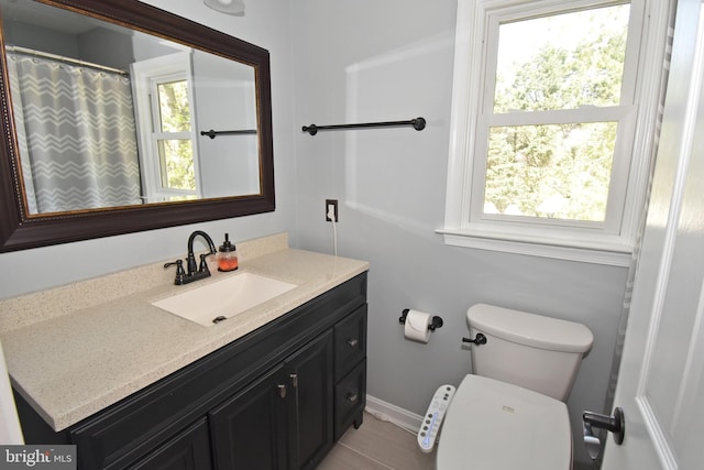 full bath featuring vanity and toilet