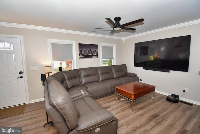 living room with baseboards, ceiling fan, ornamental molding, and wood finished floors