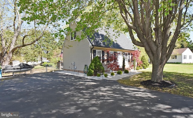 view of property exterior with aphalt driveway
