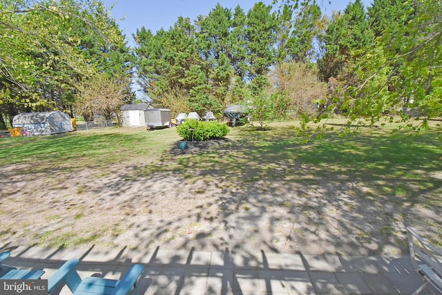 view of yard featuring a shed and an outbuilding