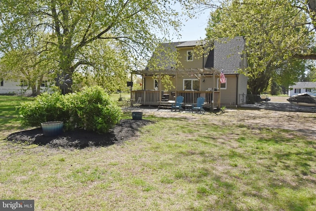 rear view of house with fence, a pergola, a shingled roof, a deck, and a lawn