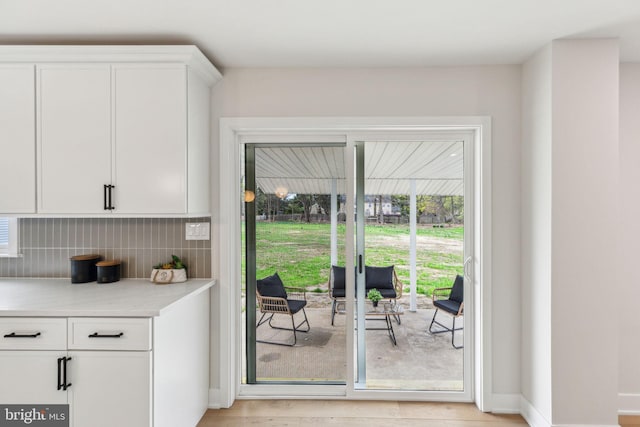 doorway to outside with light wood-style floors