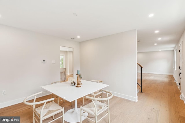 dining space featuring light wood-style flooring, baseboards, and recessed lighting