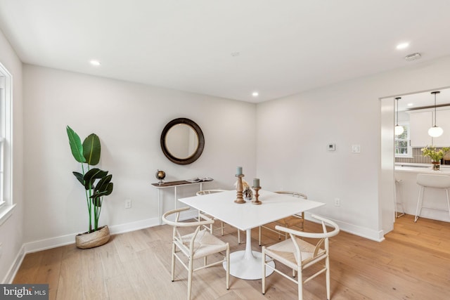 dining area featuring recessed lighting, light wood-type flooring, and baseboards
