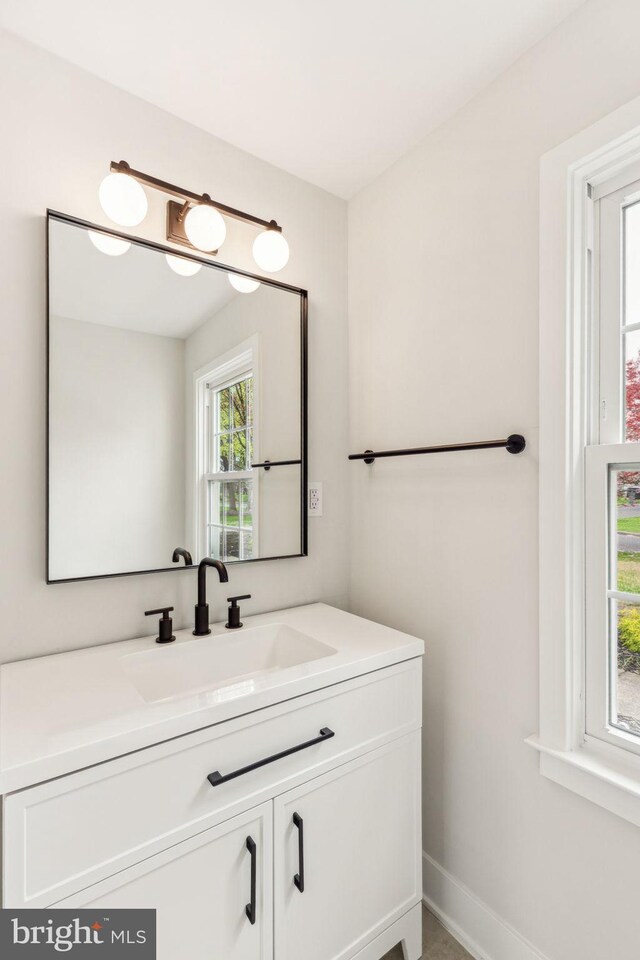 bathroom with baseboards and vanity