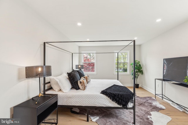 bedroom featuring baseboards, wood finished floors, and recessed lighting
