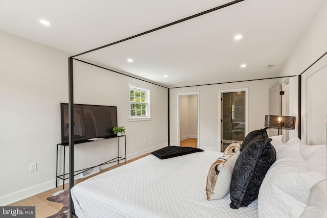 bedroom with recessed lighting, light wood-style floors, and baseboards