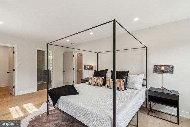 bedroom with recessed lighting, wood finished floors, and baseboards