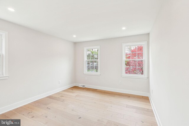 empty room featuring recessed lighting, light wood-style floors, and visible vents