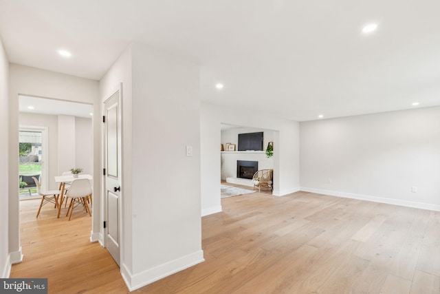interior space with baseboards, light wood-type flooring, and recessed lighting