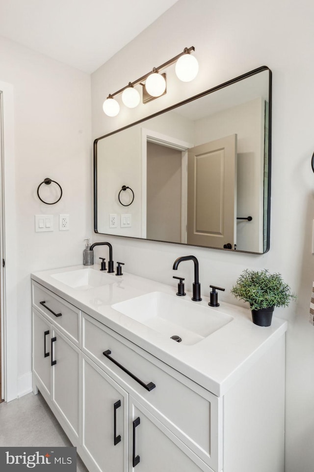 bathroom featuring a sink and double vanity