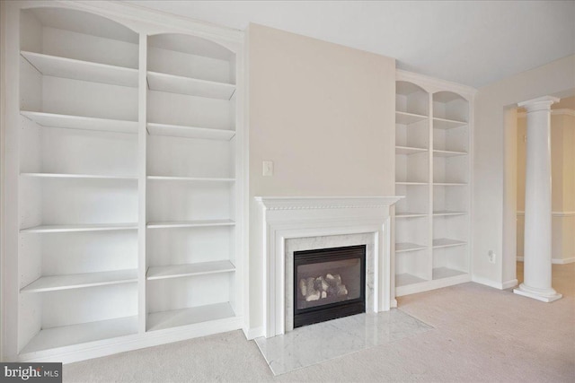 823 Oyster Bay Pl Unit 302, Solomons, MD 20688 - unfurnished living room featuring carpet flooring, decorative columns, a premium fireplace, and built in features