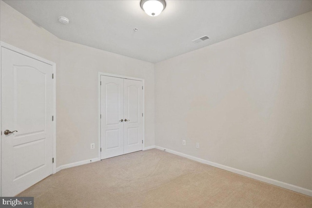 823 Oyster Bay Pl Unit 302, Solomons, MD 20688 - unfurnished bedroom with carpet flooring, a closet, and baseboards