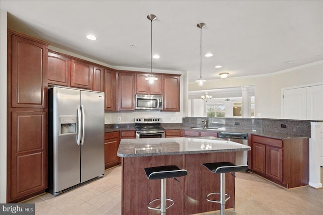 823 Oyster Bay Pl Unit 302, Solomons, MD 20688 - kitchen featuring appliances with stainless steel finishes, a breakfast bar, a peninsula, light tile patterned flooring, and a sink