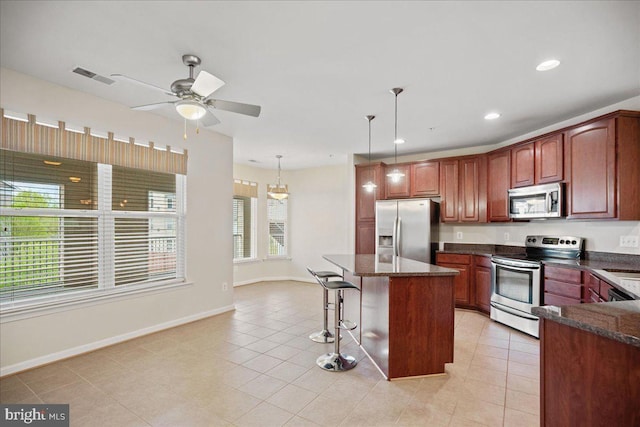 823 Oyster Bay Pl Unit 302, Solomons, MD 20688 - kitchen with appliances with stainless steel finishes, a ceiling fan, a kitchen breakfast bar, a center island, and light tile patterned floors