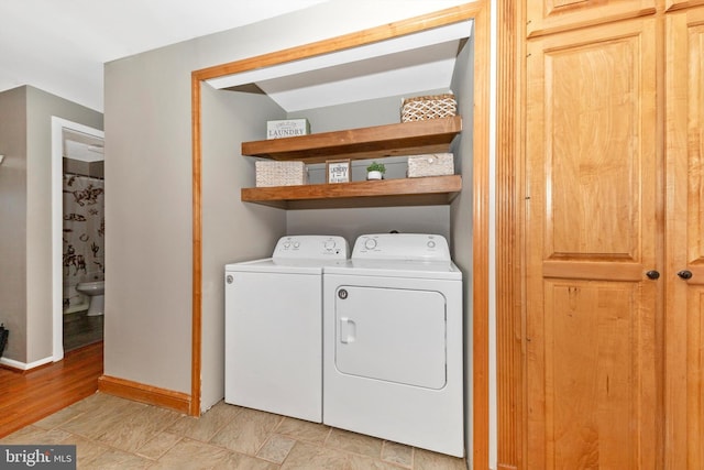 17449 Irishtown Rd, Emmitsburg, MD 21727 - washroom featuring washing machine and clothes dryer, laundry area, and baseboards