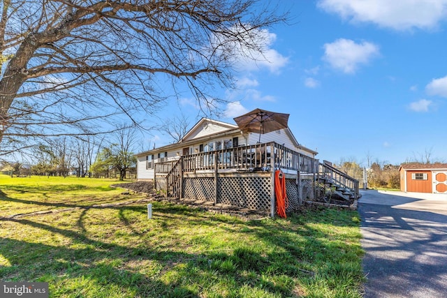 17449 Irishtown Rd, Emmitsburg, MD 21727 - rear view of property with a lawn, stairs, an outbuilding, a wooden deck, and driveway