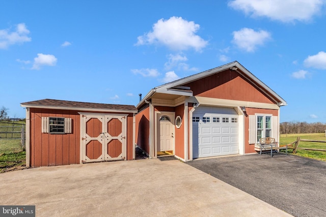 17449 Irishtown Rd, Emmitsburg, MD 21727 - view of front of home featuring aphalt driveway, a storage shed, an outdoor structure, fence, and a garage