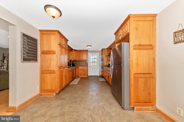 17449 Irishtown Rd, Emmitsburg, MD 21727 - kitchen with stone finish flooring, brown cabinets, baseboards, and appliances with stainless steel finishes