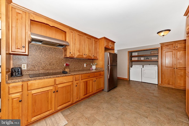 17449 Irishtown Rd, Emmitsburg, MD 21727 - kitchen with wall chimney exhaust hood, freestanding refrigerator, black electric stovetop, backsplash, and washing machine and dryer