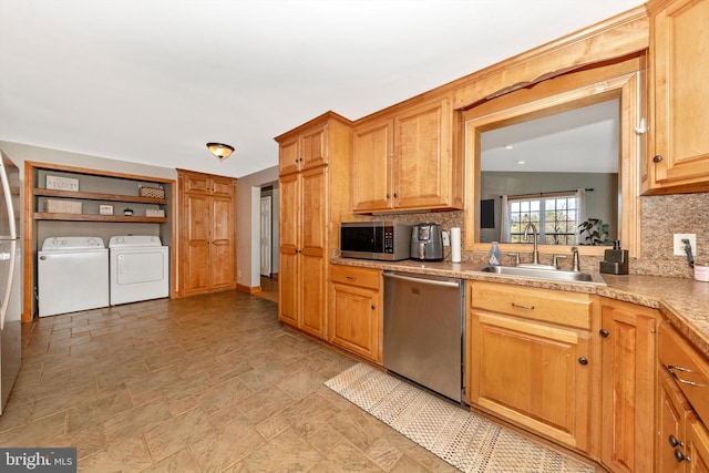 17449 Irishtown Rd, Emmitsburg, MD 21727 - kitchen featuring stainless steel appliances, washing machine and dryer, a sink, and decorative backsplash