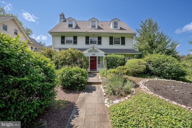 723 S Latches Ln, Merion Station, PA 19066 - view of front facade with stucco siding and a chimney