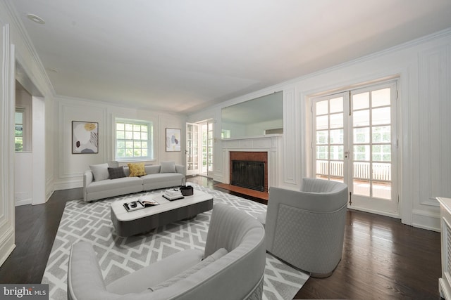723 S Latches Ln, Merion Station, PA 19066 - living area featuring ornamental molding, dark wood-style flooring, a fireplace, and a decorative wall
