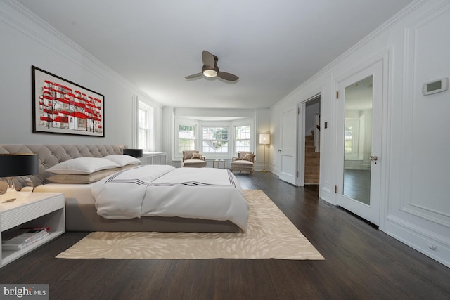 723 S Latches Ln, Merion Station, PA 19066 - bedroom featuring crown molding, dark wood-style flooring, a ceiling fan, and a decorative wall