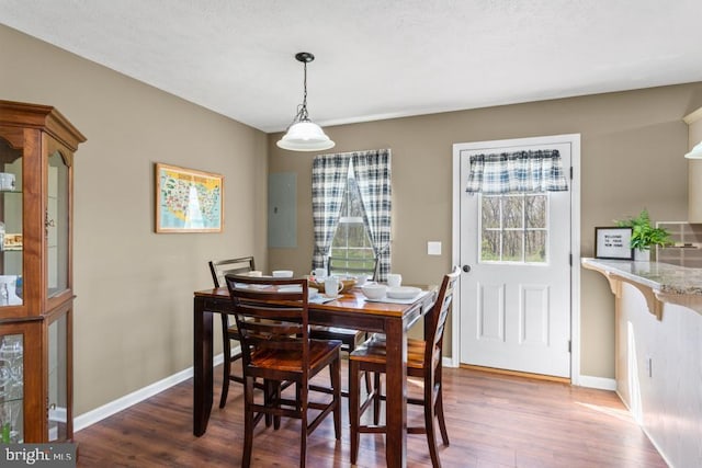 dining area featuring wood finished floors and baseboards