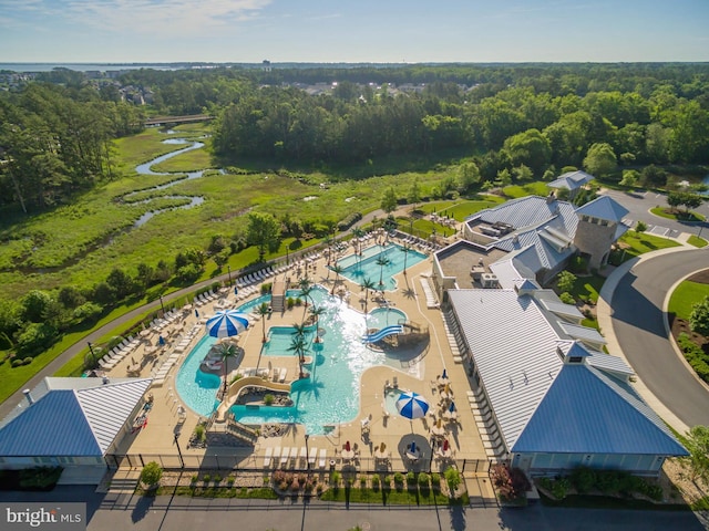 aerial view of a pool area and a forest