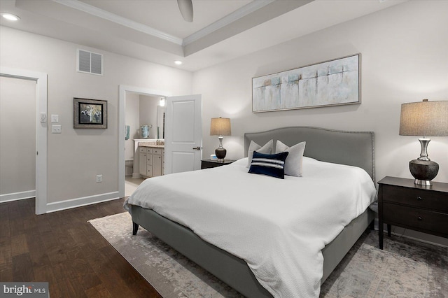 bedroom with wood finished floors, crown molding, recessed lighting, a tray ceiling, and baseboards