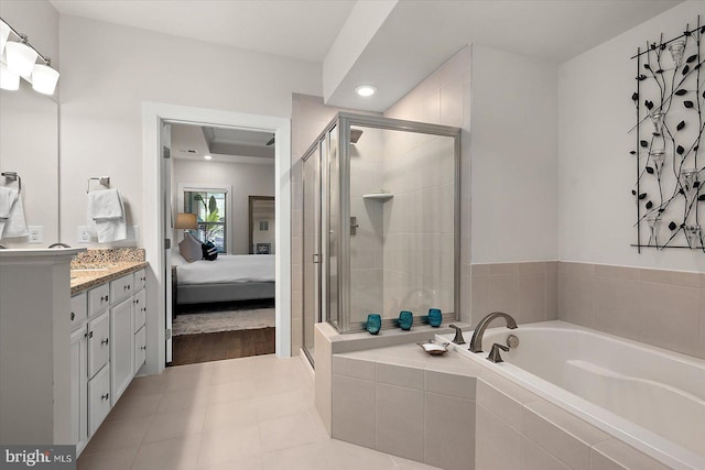 ensuite bathroom featuring a garden tub, a shower stall, vanity, and recessed lighting