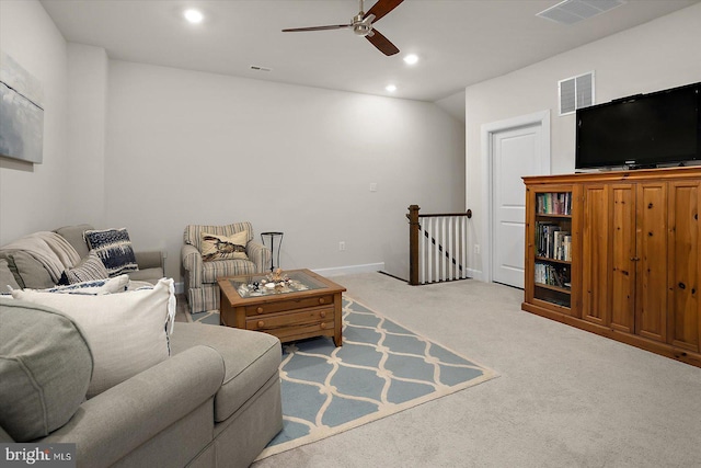 living room with a ceiling fan, recessed lighting, light carpet, and baseboards