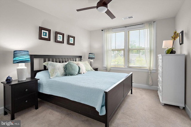 bedroom with baseboards, light colored carpet, and ceiling fan