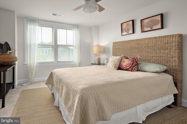 bedroom with light carpet, baseboards, and ceiling fan