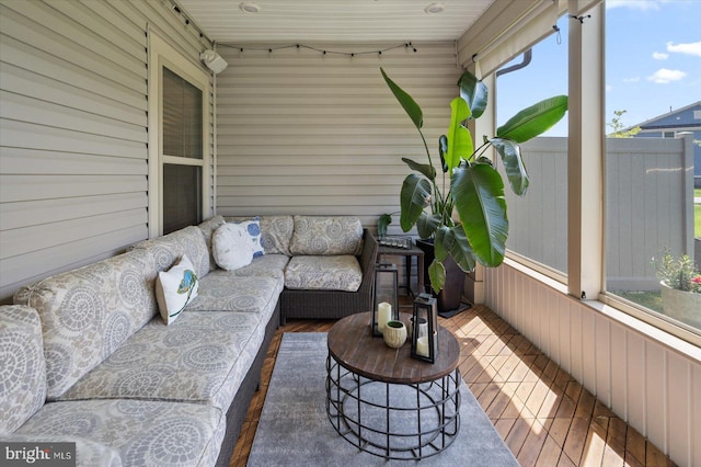 sunroom featuring an outdoor living space