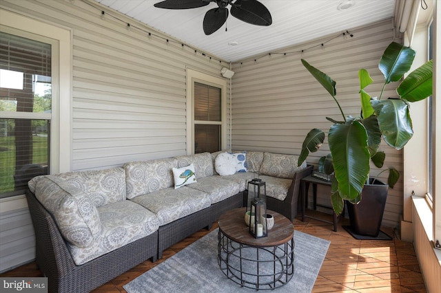 sunroom with a ceiling fan and outdoor lounge area